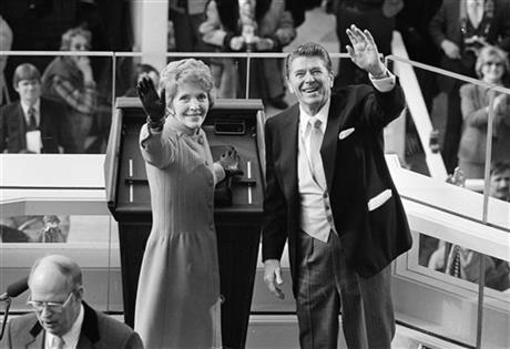 FILE - In this Jan. 20, 1981, file photo, President Ronald Reagan and first lady Nancy Reagan wave to onlookers at the Capitol building as they stand at the podium in Washington following the swearing in ceremony. The former first lady has died at 94, The Associated Press confirmed Sunday, March 6, 2016. (AP Photo/File)