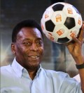 FILE - In this Oct. 12, 2015 file photo, Brazilian football legend Pele poses with a football during an interaction session with students in Kolkata, India. Pele is suing Samsung in Chicago federal court, claiming the electronics company improperly used his identity in The New York Times. The lawsuit claims Samsung used a Pele look-alike in an October advertisement for televisions after breaking off negotiations to use Pele's image. The lawsuit says the ad will confuse consumers and hurt the value of his endorsement rights. It seeks $30 million in damages. (AP Photo/Bikas Das File)