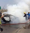 ire fighters extinguish a burning car that was slammed into by a black Mercedes killing it's two occupants on a Thai highway on March 13, 2016. The smaller car burst into flames and the couple inside, both graduate students in their 30s, died at the scene of the accident. (Senior Sergeant Major Parichart Pangrith via AP)