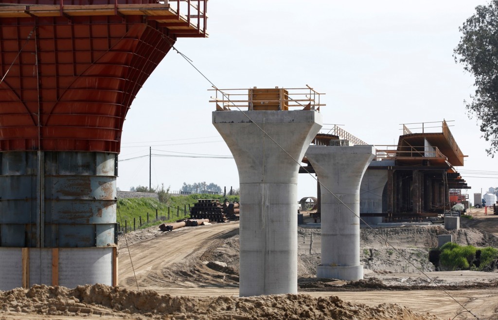 In this Friday, Feb. 26, 2016, photo, the supports for a 1,600-foot-viaduct to carry high-speed rail trains across the Fresno River are seen under construction near Madera, Calif. Sacramento County Superior Court Judge Michael Kenny ruled against plaintiffs in a lawsuit to stop construction of the project, ruling Tuesday, March 8, 2016 that planning and financing of the $64 billion bullet train can proceed. (AP Photo/Rich Pedroncelli)
