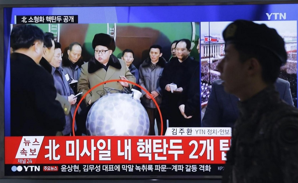 A South Korean army soldier passes by a TV news program showing North Korean leader Kim Jong Un, at Seoul Railway Station in Seoul, South Korea, Wednesday, March 9, 2016. The official North Korean news agency says the communist country's leader Kim his nuclear scientists for a briefing and declared he was greatly pleased that warheads had been miniaturized for use on ballistic missiles. The letters at the screen read "North Korea' nuclear warhead ". (AP Photo/Ahn Young-joon)