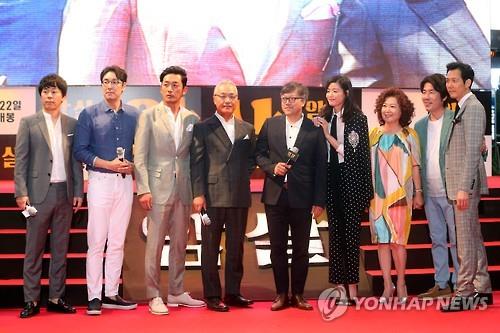The stars of the movie "Assassination" -- Choi Duk-moon, Jo Jin-woong, Ha Jung-woo, Lee Kyung-young, Jeon Ji-hyun, Kim Hye-sook, Oh Dal-soo and Lee Jung-jae -- along with director Choi Dong-hoon (C) poses for a photo during a publicity event in Seoul on July 7, 2015. The movie was released in South Korea on July 22.