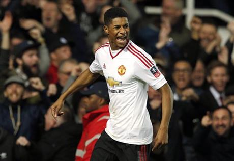 Manchester United’s Marcus Rashford celebrates after scoring his side's first goal during the English FA Cup quarterfinal soccer match against West Ham at Boleyn Ground stadium in London. Teenage striker Marcus Rashford was selected in England's provisional 26-man squad Monday, May 16, 2016 ahead of the European Championship, less than three months after making his debut for Manchester United. The 18-year-old Rashford has established himself as United's No. 1 striker in the final months of this season, scoring seven goals, and was one of five strikers selected by coach Roy Hodgson in an enlarged group for warm-up matches against Turkey, Australia and Portugal. (AP Photo/Alastair Grant, file)