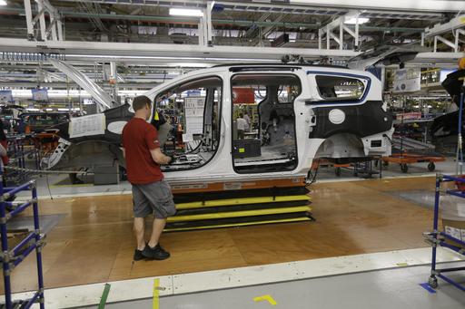 Steve Vince works on a 2017 Chrysler Pacifica on the assembly line at the Windsor Assembly Plant, Friday, May 6, 2016, in Windsor, Ontario. Fiat Chrysler Automobiles and Google announced Tuesday, May 3, that they will work together to more than double the size of Google's self-driving vehicle fleet by adding 100 Chrysler Pacifica minivans. (AP Photo/Carlos Osorio)