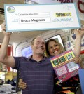 Bruce Magistro, left, and lottery representative Yolanda Vega pose for a picture during a news conference in Babylon, N.Y., Wednesday, May 11, 2016. Magistro, who won $1 million in the New York Lottery for a second time, remembers thinking: "This is impossible." (AP Photo/Seth Wenig)