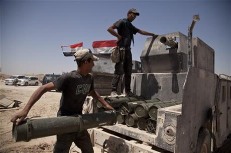 Iraqi counterterrorism forces load a Humvee with rockets to take to a front line position in their fight to oust Islamic State militants from Fallujah, Iraq, Tuesday, June 7, 2016. (AP Photo/Maya Alleruzzo)