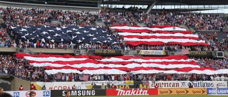 In this June 7, 2016, file photo, United States fans display the American flag during the national anthem before a Copa America Centenario group A soccer match between the United States and Costa Rica, at Soldier Field in Chicago. American soccer fans can watch a quintuple-header of major international tournament matches Saturday, the first of six in the next week-and-a-half.