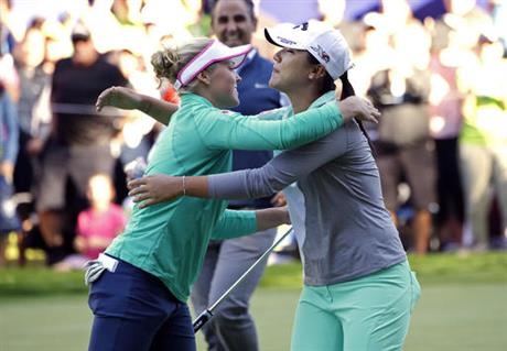 Brooke Henderson, of Canada, left, embraces Lydia Ko, of New Zealand, after Henderson won on the 18th green in a playoff hole in the Women's PGA Championship golf tournament at Sahalee Country Club Sunday, June 12, 2016, in Sammamish, Wash.