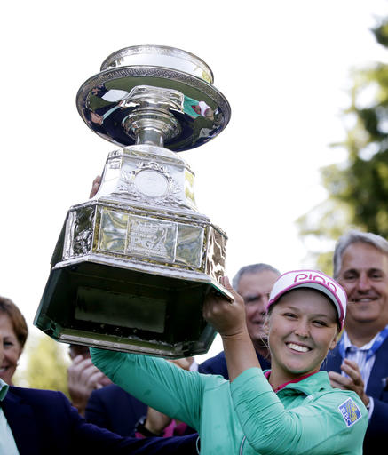 Brooke Henderson, of Canada, lifts the championship trophy after winning the Women's PGA Championship golf tournament at Sahalee Country Club on Sunday, June 12, 2016, in Sammamish, Wash.