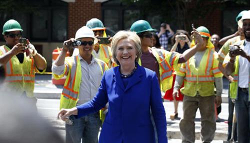 Democratic presidential candidate Hillary Clinton smiles after greeting workers after a stop at Uprising Muffin Company, Friday, June 10, 2016, in Washington.