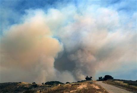 Heavy smoke rises over a hill as a wildfire burns west of Goleta, Calif., Friday, June 17, 2016. The latest size estimate Friday morning is nearly three times the previous acreage, with just 5 percent containment. The fire has been stoked by the region's afternoon and evening "Sundowner" winds, which blast down the face of the Santa Ynez Mountains toward the Pacific Ocean.