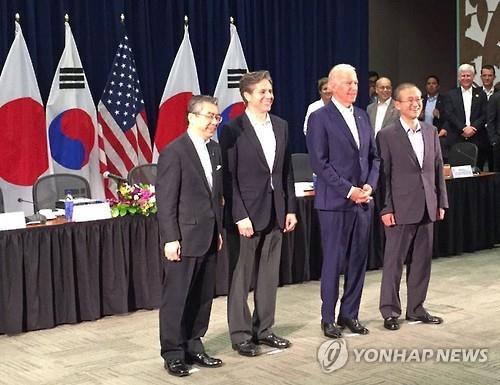 South Korea's Vice Foreign Minister Lim Sung-nam (R) poses next to U.S. Vice President Joseph Biden along with his two counterparts from Washington and Japan after holding a trilateral meeting in Hawaii on Thursday. 