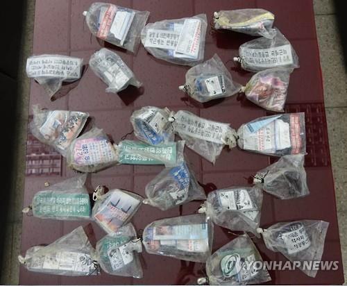 In this photo provided by the South Korean military on July, 27, 2016, vinyl bags carrying North Korean leaflets are displayed on a table.