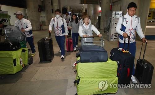 South Korean Olympic judokas walk through Santos Dumont Airport in Rio de Janeiro after arriving in the Summer Games host city on Aug. 3, 2016.