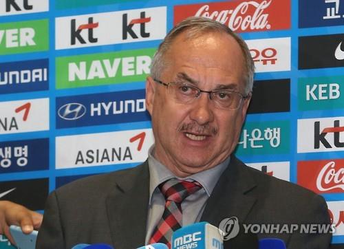 In this file photo taken on June 7, 2016, South Korean men's national football team coach Uli Stielike speaks to reporters at Incheon International Airport.