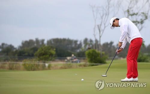 South Korean golfer Wang Jeung-hun takes a putt during the first round of the men's golf competition at the Rio de Janeiro Olympics on Aug. 11, 2016.