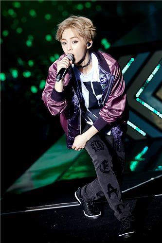 In this photo released by S.M. Entertainment, Xiumin of South Korean boy group EXO performs during the group's Seoul concert "EXO Planet #3 - The EXO'rDIUM" at Olympic Park stadium, southeastern Seoul, on July 24, 2016.