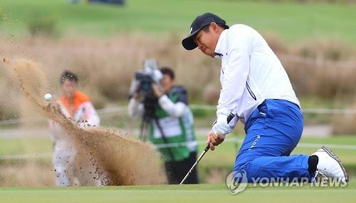 South Korean golfer An Byeong-hun hits a bunker shot during the second round of men's golf at the Rio de Janeiro Olympics on Aug. 12, 2016. 
