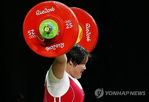 In this EPA photo, North Korean weightlifter Kim Kuk-hyang competes during the women's +75kg category at the Rio de Janeiro Olympics on Aug. 14, 2016.