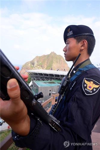A South Korean police officer stands guard on Dokdo on Aug. 15, 2016. 
