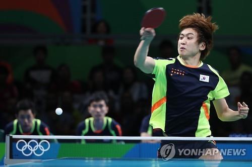 South Korean table tennis player Jeoung Young-sik returns a shot during the men's team bronze medal match against Germany at the Rio de Janeiro Olympics on Aug. 17, 2016. 