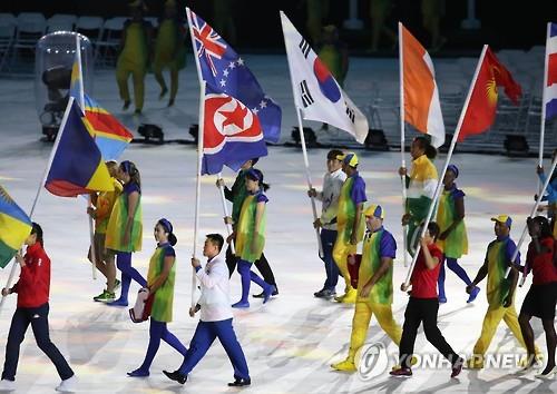 Flagbearers for North Korea and South Korea march into Maracana Stadium during the closing ceremony of the Rio de Janeiro Olympics on Aug. 21, 2016. 