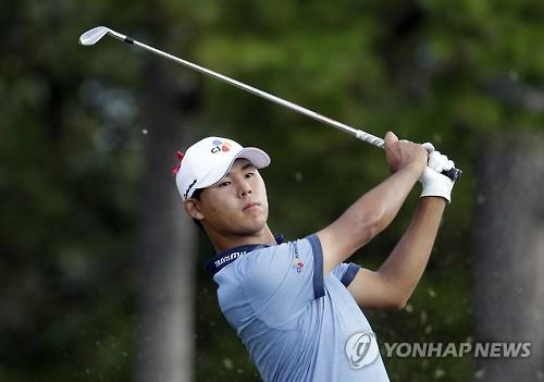 In this Associated Press photo, Kim Si-woo of South Korea watches his tee shot on the 16th hole during the final round of the Wyndham Championship in Greensboro, North Carolina, on Aug. 21, 2016.