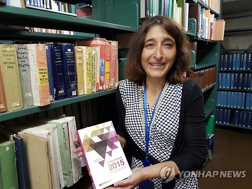 Cristina Giordano holds a copy of "Korea Annual 2015," an English-language almanac published by South Korea's key newswire service Yonhap News Agency, on Sept. 1, 2016.