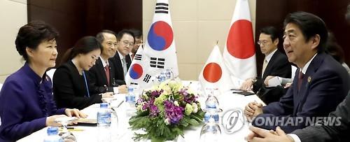 President Park Geun-hye (L) and her Japanese counterpart Shinzo Abe hold a summit on the sidelines of multiple summits with the leaders of the Association of Southeast Asian Nations in the Laotian capital of Vientiane on Sept. 7, 2016.