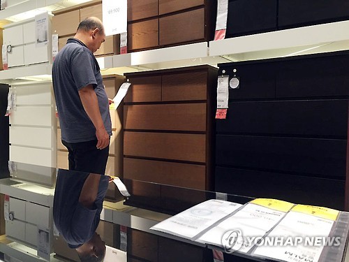 A customer is looking at the tag of a Malm dresser displayed in the IKEA store in Gwangmyung, south of Seoul, on July 7, 2016. 