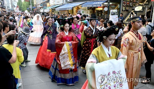 A traditional hanbok fashion parade trails through Insadong, an antique and art gallery street in downtown Seoul on Sept. 12, 2016. 