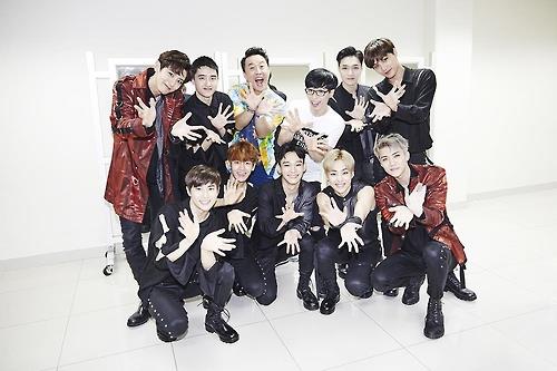 This undated file photo provided by S.M. Entertainment shows South Korean boy band EXO and comedian Yoo Jae-suk. 