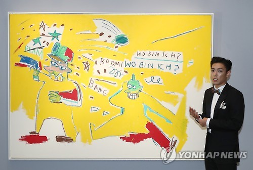 BigBang's T.O.P introduces an artwork to reporters during a press preview of the Oct. 3 auction in Seoul on Sept. 19, 2016.