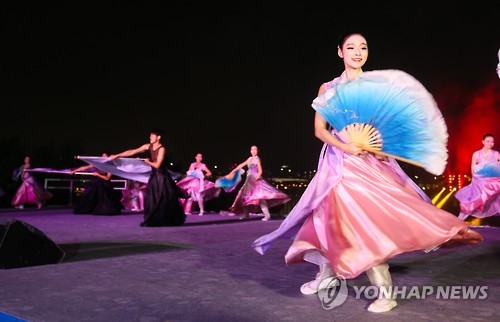 Dancers perform on a stage in Yeouido Park by the Han River in Seoul during the ceremony commemorating the 500-day countdown to the 2018 PyeongChang Winter Olympics on Sept. 27, 2016.