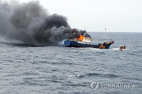 This photo provided by the Coast Guard in Mokpo shows a Chinese fishing boat on fire during a crackdown on illegal fishing on Sept. 29, 2016. 