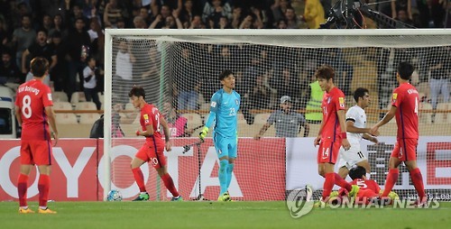 South Korean football players react after conceding a goal against Iran during their 2018 FIFA World Cup qualifier at Azadi Stadium in Tehran on Oct. 11, 2016. 