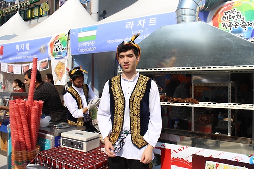 A staff selling Uzbek food poses for a photo during the Itaewon Global Village Festival in Itaewon, central Seoul, on Oct. 15, 2016.