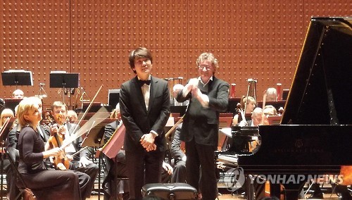 South Korean pianist Cho Seong-jin bows to the audience during his concert with Warsaw Philharmonic Orchestra at the Lincoln Center in New York on Oct. 24, 2016.
