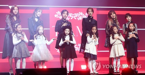Members of South Korean girl group T-ara perform with little girls in the media showcase for their 12th and latest EP "Remember" in central Seoul on Nov. 9, 2016.