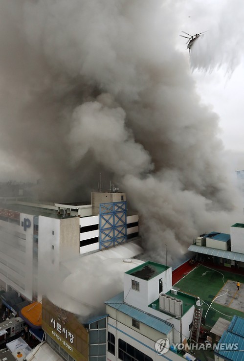 Thick smoke billows from the Seomun traditional market in Daegu, some 300 kilometers southeast of Seoul, on Nov. 30, 2016, as a fire rips through it. About 840 shops were reduced to ashes, with two firefighters sustaining injuries. 