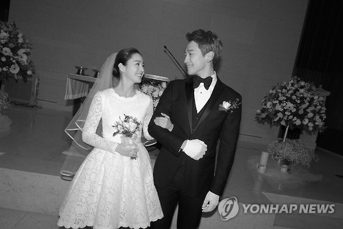In this photo provided by the Rain Company, singer-actor Rain and actress Kim Tae-hee smile during their wedding at Gahoe-dong Church in central Seoul on Jan. 19, 2017.