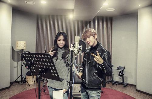 This undated photo provided by Starship Entertainment shows singers Soyou (L) and Baekhyun posing for the camera at a recording studio for their duet song "Rain."