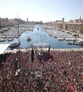 Supporters of French hard-left presidential candidate Jean-Luc Melenchon gather in Marseille’s Old Port, southern France, to attend a campaign rally, Sunday, April 9, 2017. The two-round presidential election is set for April 23 and May 7. (AP Photo/Claude Paris)