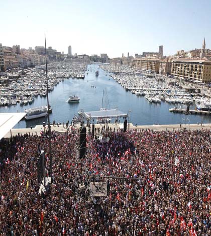 Supporters of French hard-left presidential candidate Jean-Luc Melenchon gather in Marseille’s Old Port, southern France, to attend a campaign rally, Sunday, April 9, 2017. The two-round presidential election is set for April 23 and May 7. (AP Photo/Claude Paris)