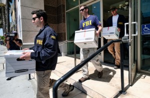  Federal agents carried out boxes of evidence after a raid this month on a California business accused of helping wealthy Chinese investors fraudulently obtain green cards. Credit Richard Vogel/Associated Press 