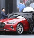 Sang Yup Lee, a head of Genesis Styling, left, and Luc Donckerwolke, a head of Genesis Design Center, second from right, unveil the new sedan Genesis G70 during its an unveiling ceremony in Hwaseong, South Korea, Friday, Sept. 15, 2017. Hyundai Motor will launch its first midsize sports sedan under the Genesis brand in South Korea next week and in the U.S. early next year, the latest attempt by the emerging Korean luxury brand to challenge BMW's 3 series and other European premium cars. (Photo: Lee Jin-man, AP)