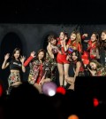 This photo provided by JYP Entertainment shows girl group TWICE waving to fans on stage during a two-day meet-and-greet event marking its two-year debut anniversary at Kyunghee University in Seoul held Oct. 14-15. (Yonhap)