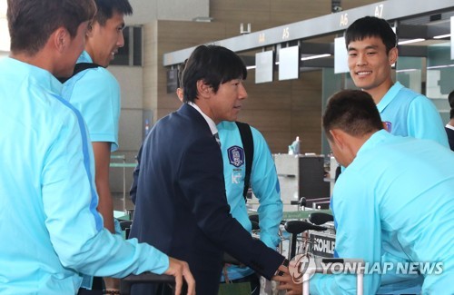 South Korea national football team head coach Shin Tae-yong (C) shakes hands with players at Incheon International Airport, west of Seoul, on Oct. 2, 2017. (Yonhap)