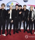 In this photo released by AP, members of BTS pose for photographers upon arriving at the American Music Awards at the Microsoft Theater in Los Angeles on Nov. 19, 2017. (Yonhap)