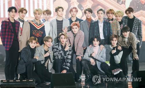 In this file photo, NCT pose for photos at a media showcase for its album, "NCT 2018 Empathy," at Korea University's Hwajung Gymnasium in Seoul on March 14, 2018. (Yonhap)